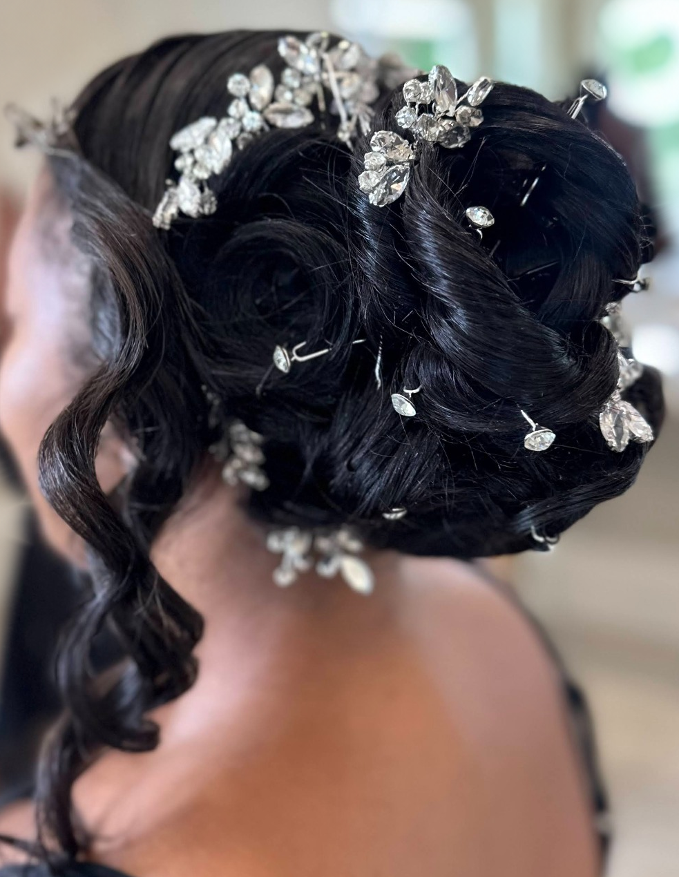 Bridal updo with crystal vines and face-framing curls · TEXTURES Hair Salon