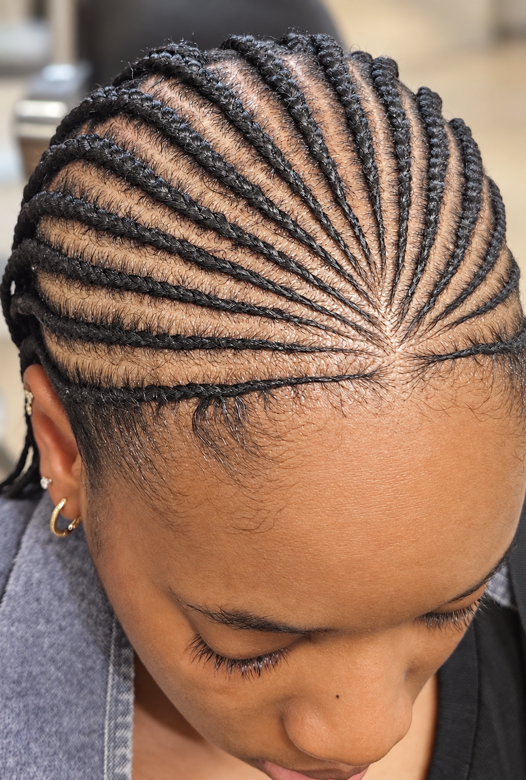 Client looking down with curved cornrows