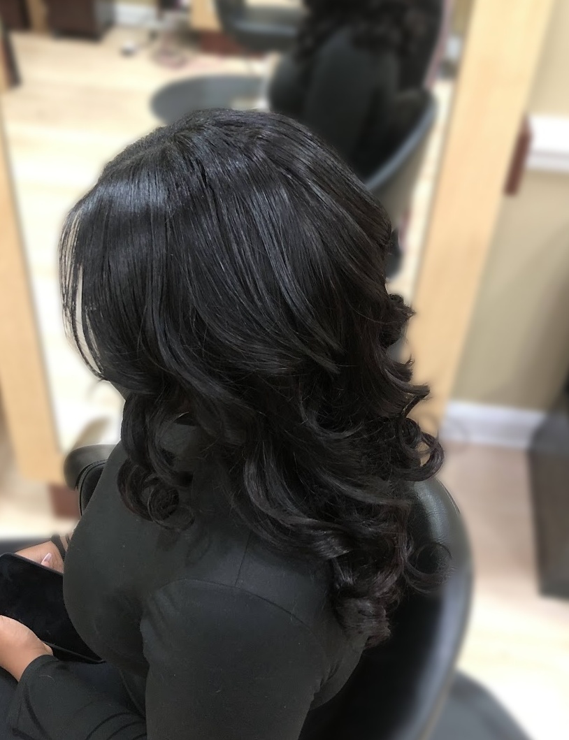 Extensions · flowing curls · back view at TEXTURES Hair Salon