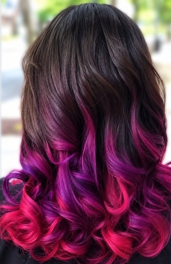 Purple and pink curls on a client at TEXTURES Hair Salon
