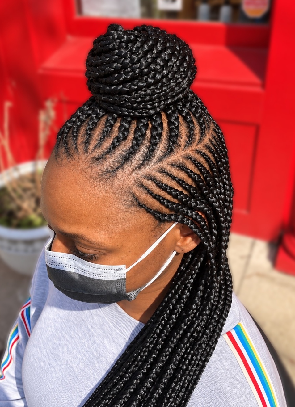 Braided bun with long braids on a client at TEXTURES Hair Salon