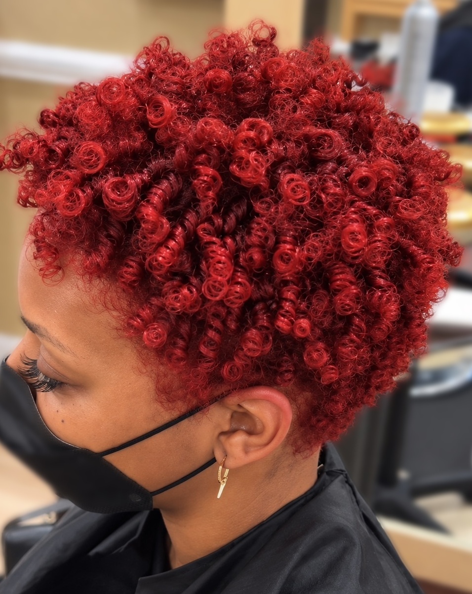 Red defined curls on a client at TEXTURES Hair Salon