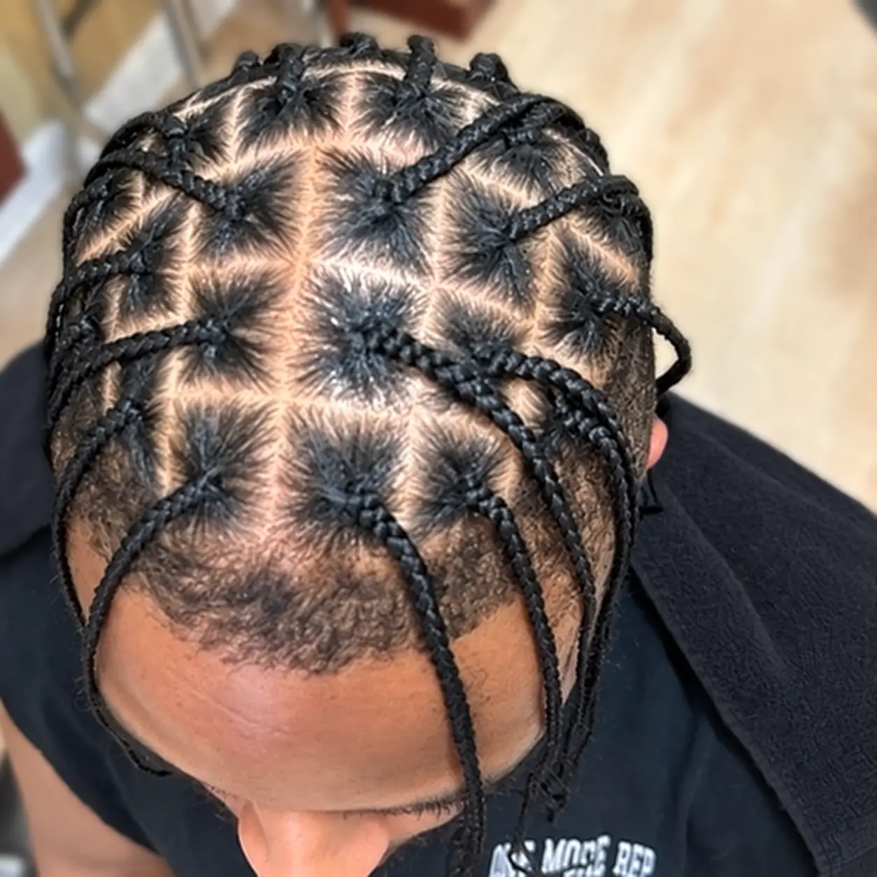 Individual braids with geometric parting · top view on a client at TEXTURES Hair Salon
