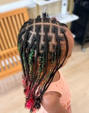 Colorful individual braids with curled ends · side view at TEXTURES Hair Salon