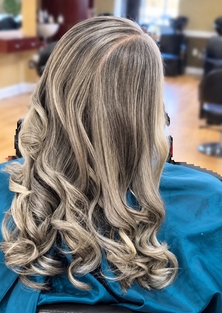 Gray hair with long curls on a client at TEXTURES Hair Salon