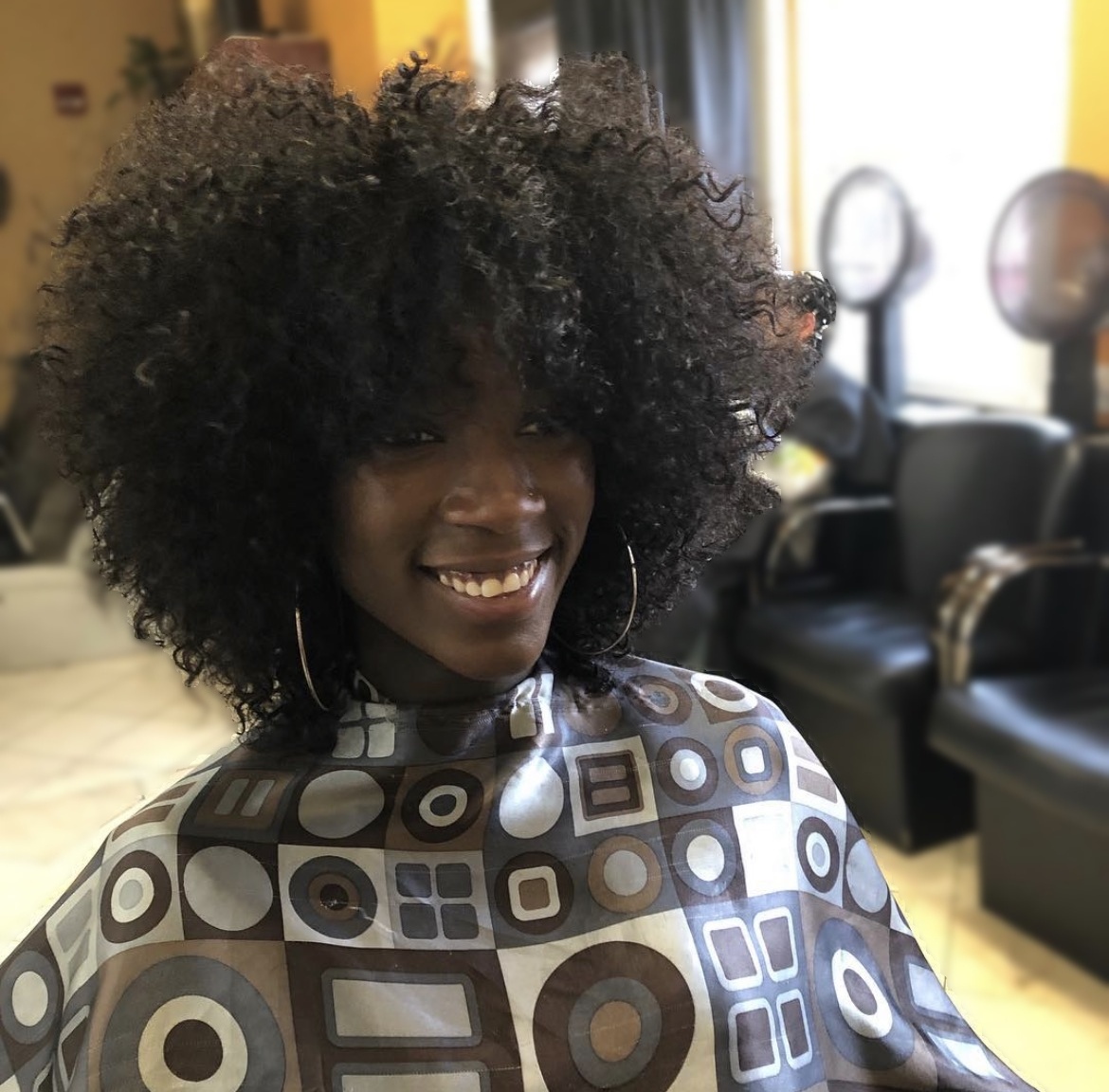 Voluminous natural curls at TEXTURES Hair Salon