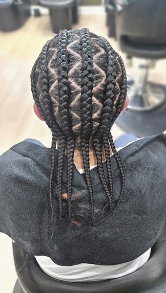 Cornrows with geometric parting at TEXTURES Hair Salon