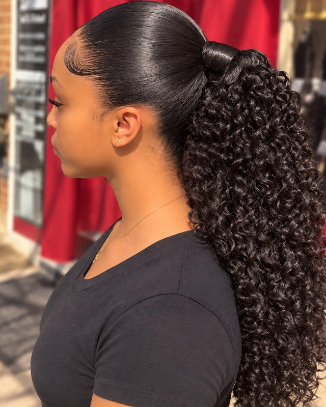 Curly ponytail with sleek styling at TEXTURES Hair Salon