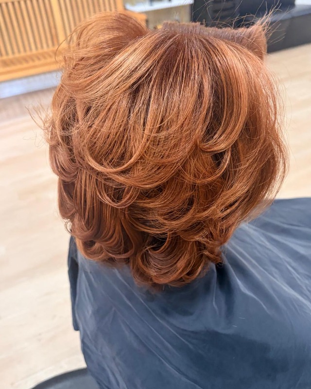 Copper layered short hairstyle at TEXTURES Hair Salon