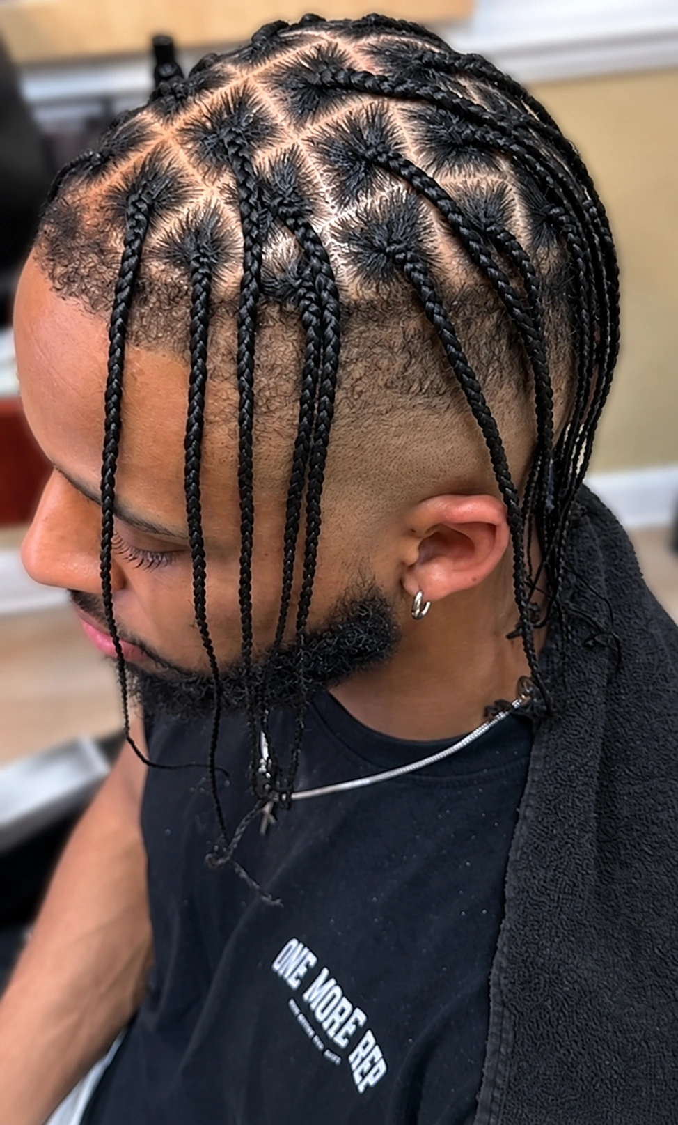 Individual braids with geometric parting · side view on a client at TEXTURES Hair Salon