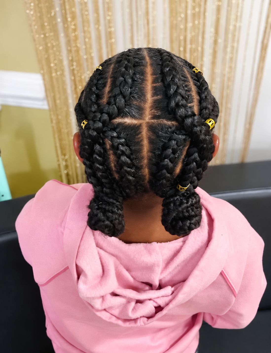 Kids’ cornrows with braided buns and gold accents by Jada