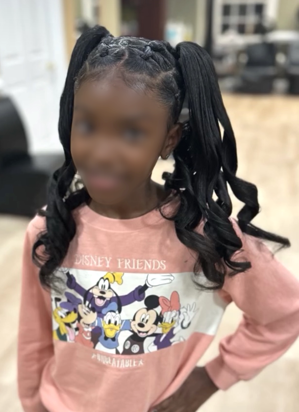 Braided double ponytails with curls · front view at TEXTURES Hair Salon
