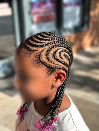 Curved cornrows with pink beads on a client at TEXTURES Hair Salon