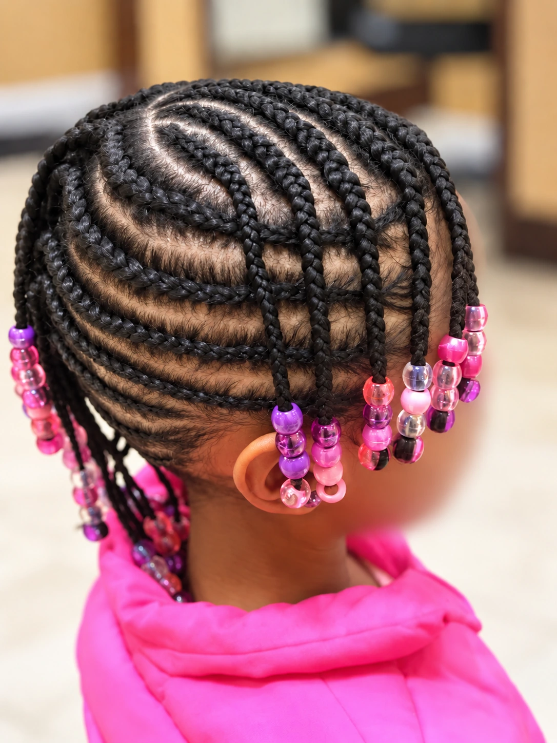 Kids’ Hair · Curved cornrows with pink and purple beads · TEXTURES Hair Salon