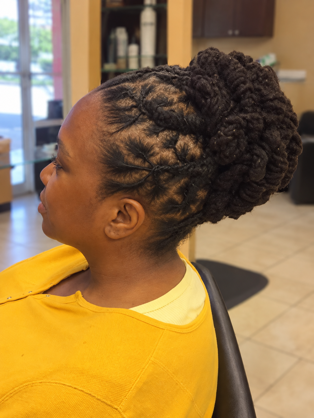 Upright side view of a loc updo