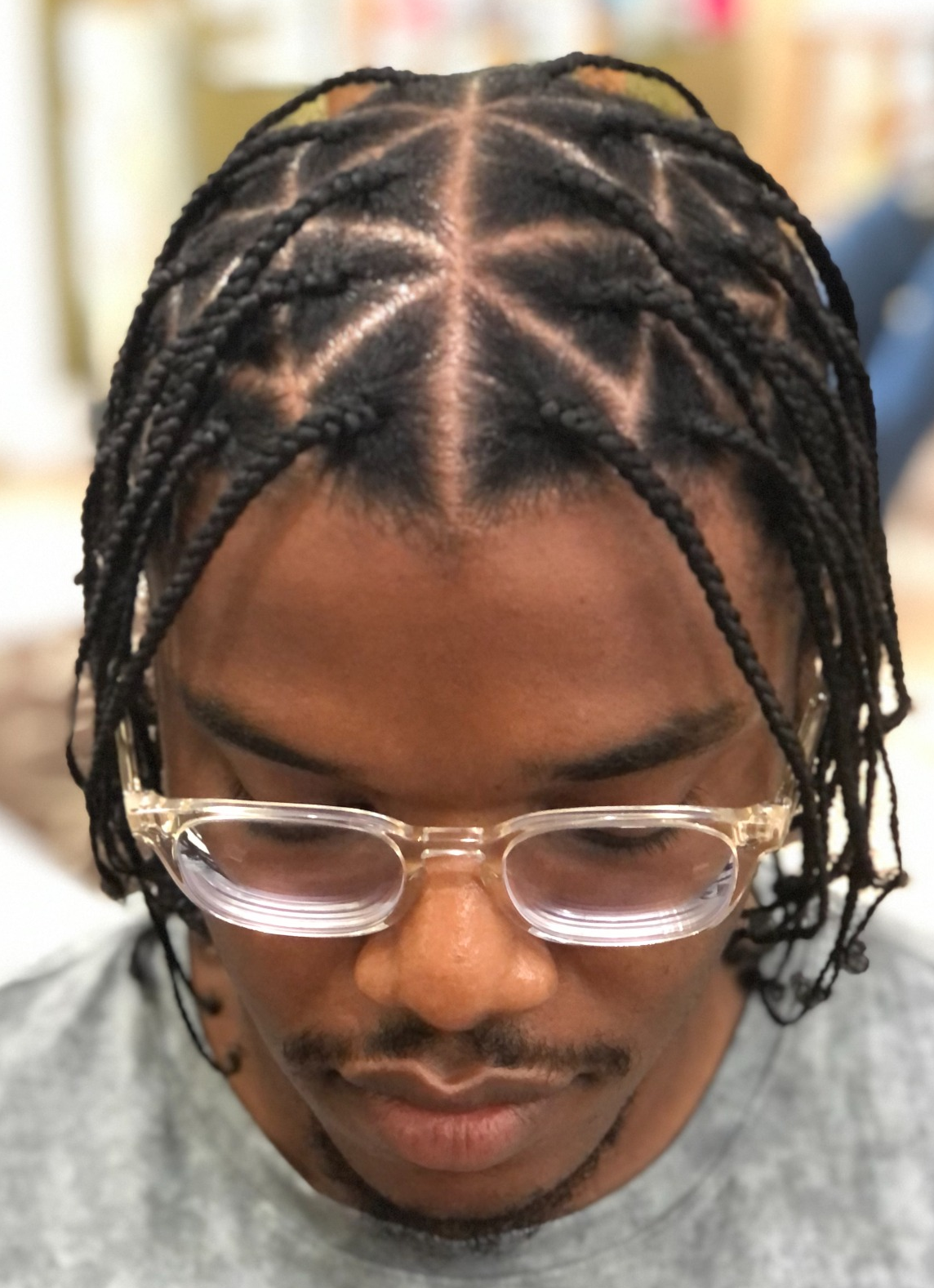 Individual braids with star-shaped parting · front view at TEXTURES Hair Salon
