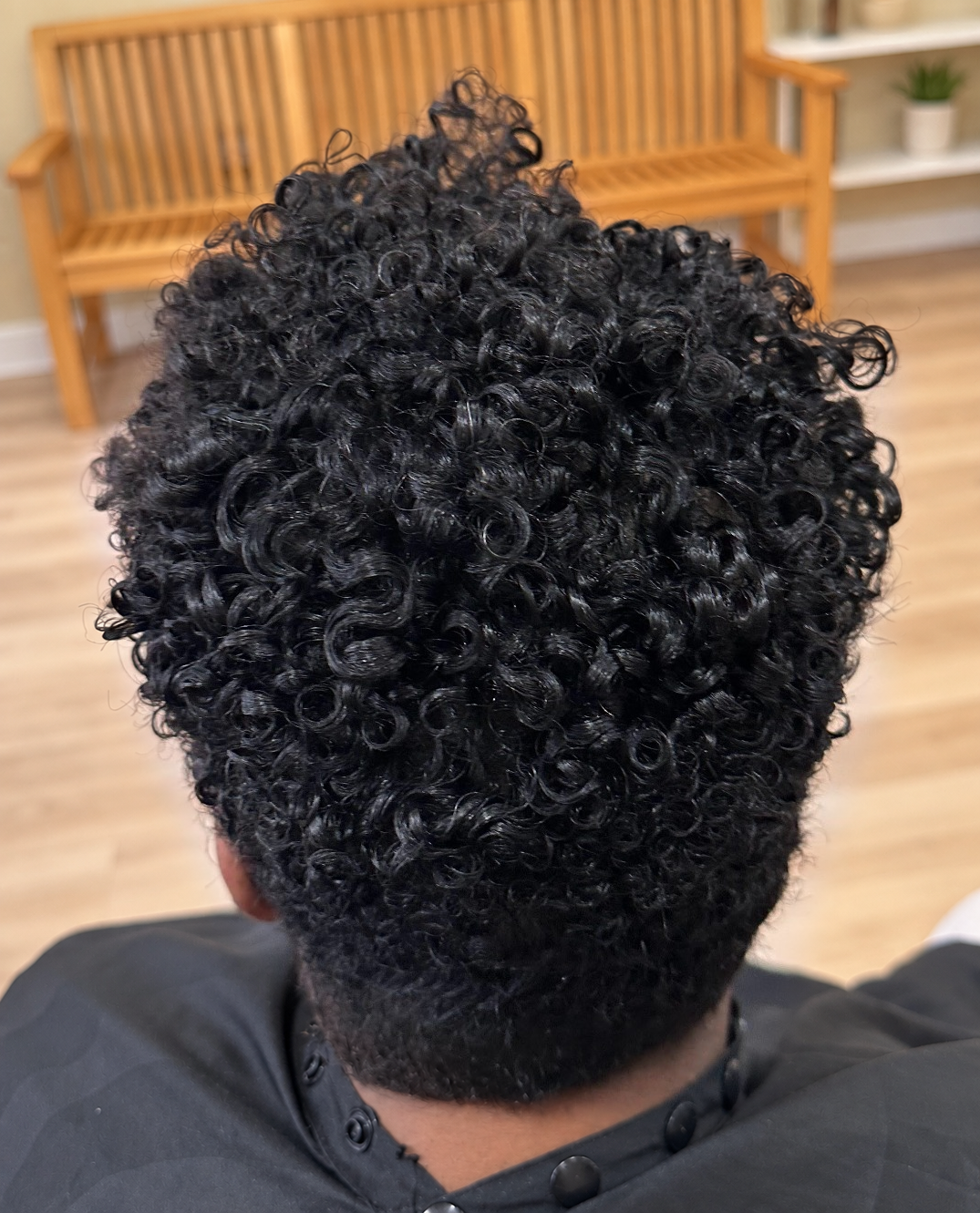 Defined curls · back view at TEXTURES Hair Salon