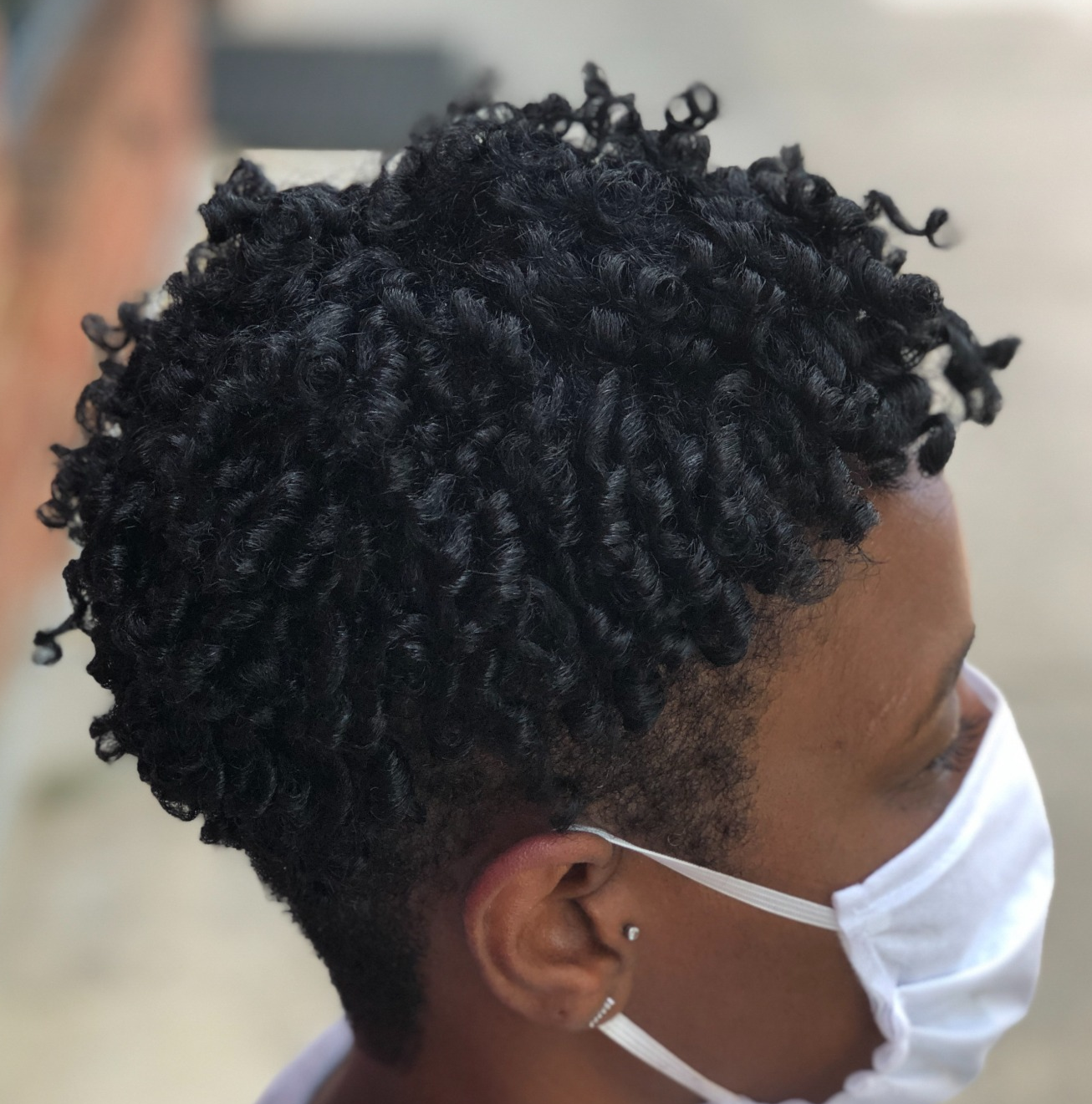 Short defined curls · side view at TEXTURES Hair Salon