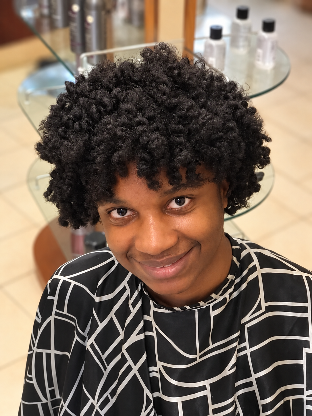 Smiling client with defined curls