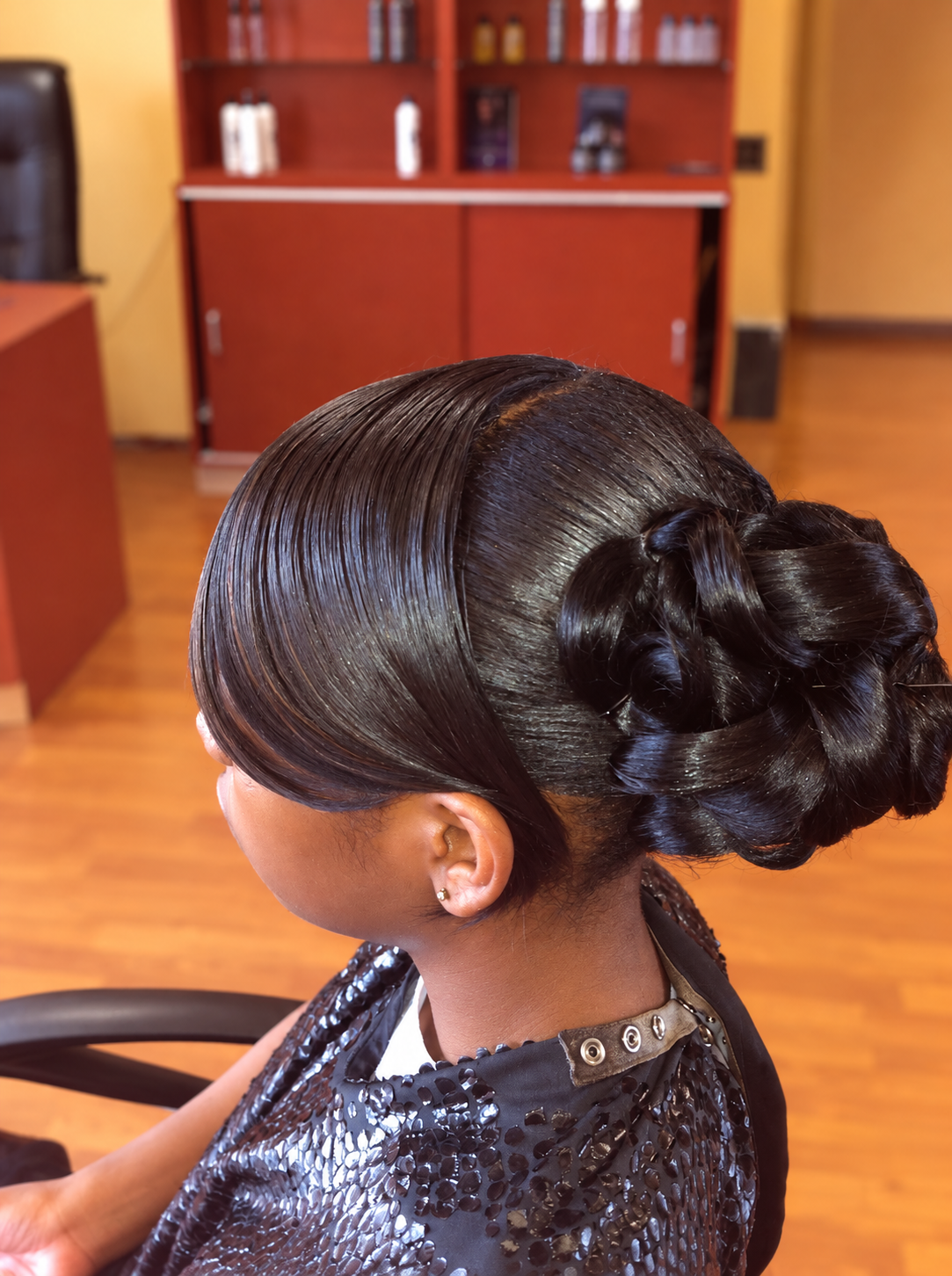 Sleek sculpted low bun by Patricia