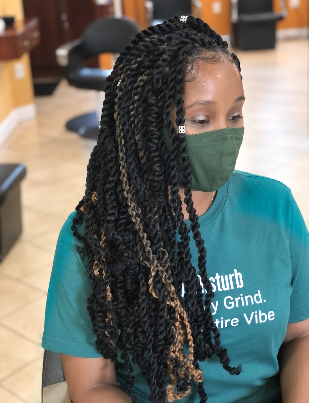 Long twists with loose curls and golden accents at TEXTURES Hair Salon