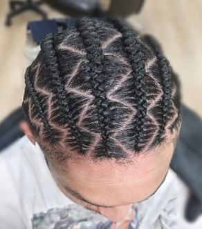 Cornrows with geometric parting on a client at TEXTURES Hair Salon