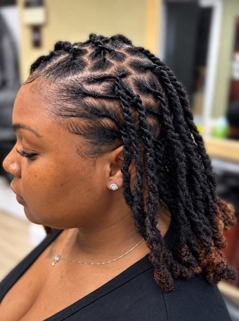 Twisted loc style with copper ends at TEXTURES Hair Salon