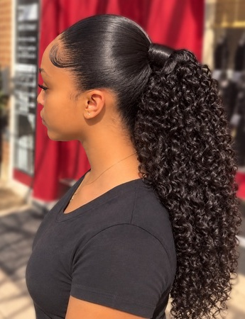 Sleek ponytail with long curls at TEXTURES Hair Salon