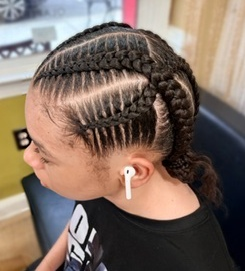 Cornrows gathered at the back at TEXTURES Hair Salon