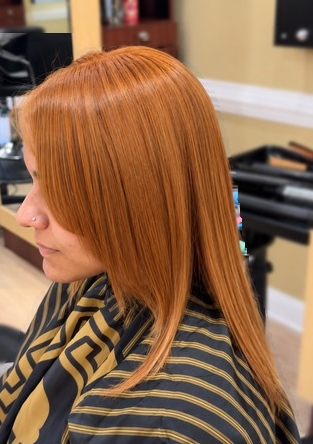 Sleek copper shoulder-length style at TEXTURES Hair Salon