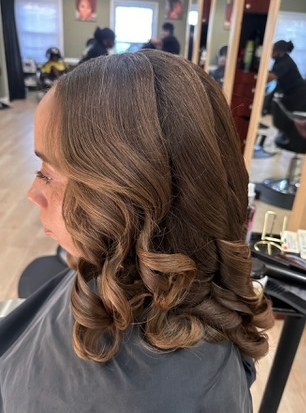 Silk press & curls · brunette side view at TEXTURES Hair Salon