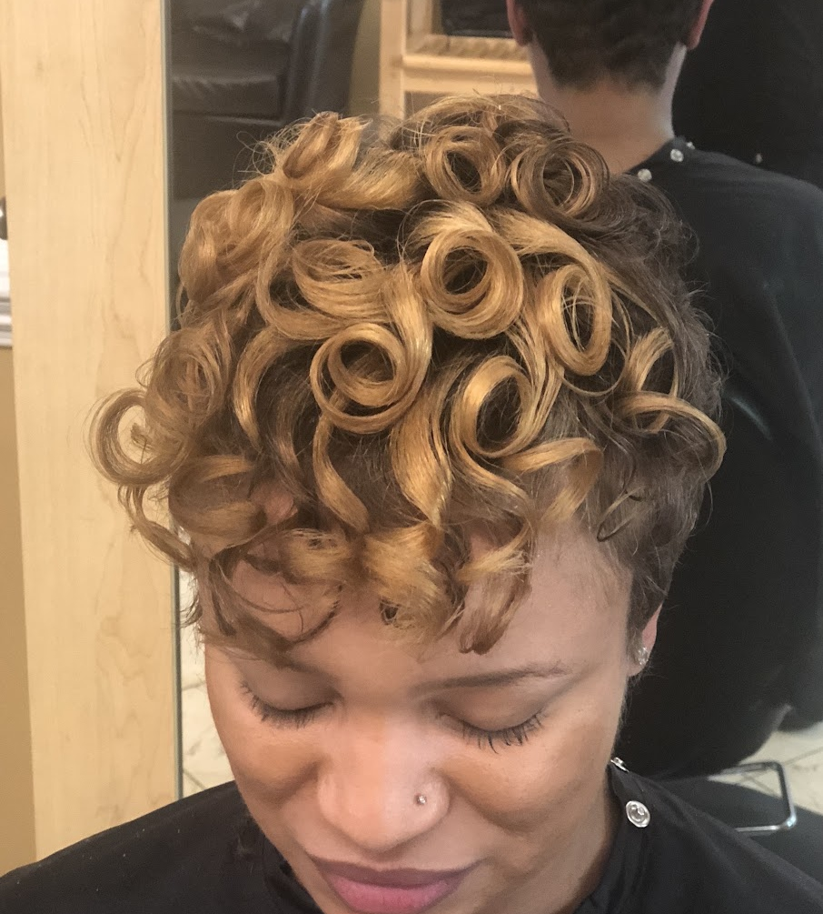 Short cut with golden curls at TEXTURES Hair Salon