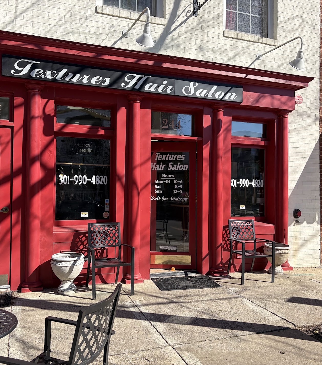 The red storefront of TEXTURES Hair Salon at 244 Main Street