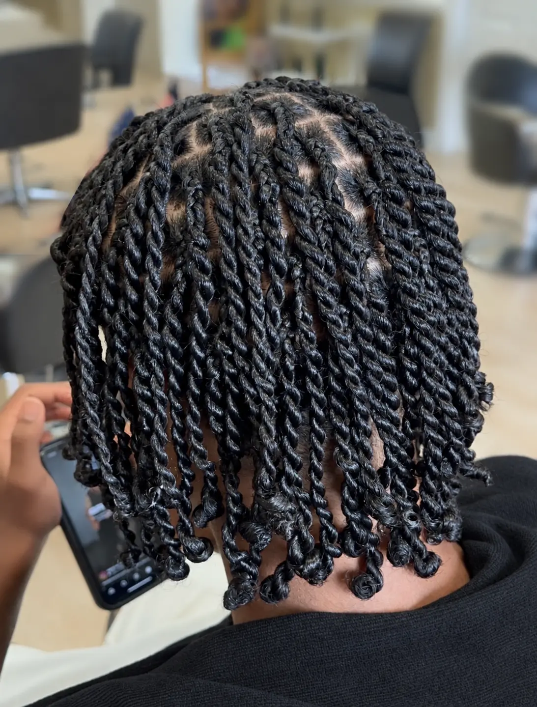 Two-strand twists with curled ends · back view at TEXTURES Hair Salon