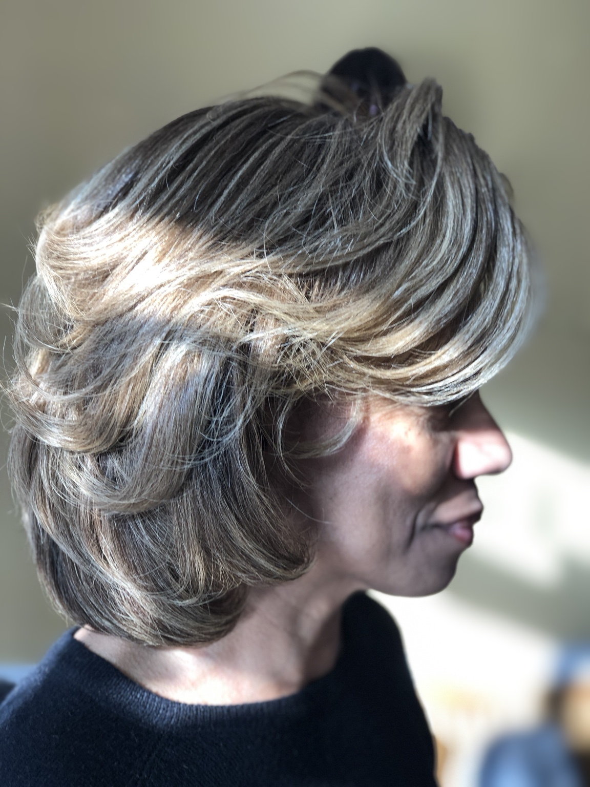 Highlighted feathered bob · side view at TEXTURES Hair Salon