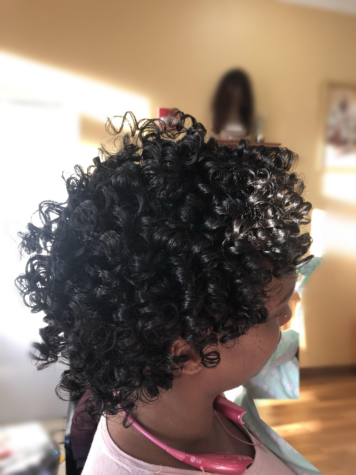 Short dark defined curls at TEXTURES Hair Salon