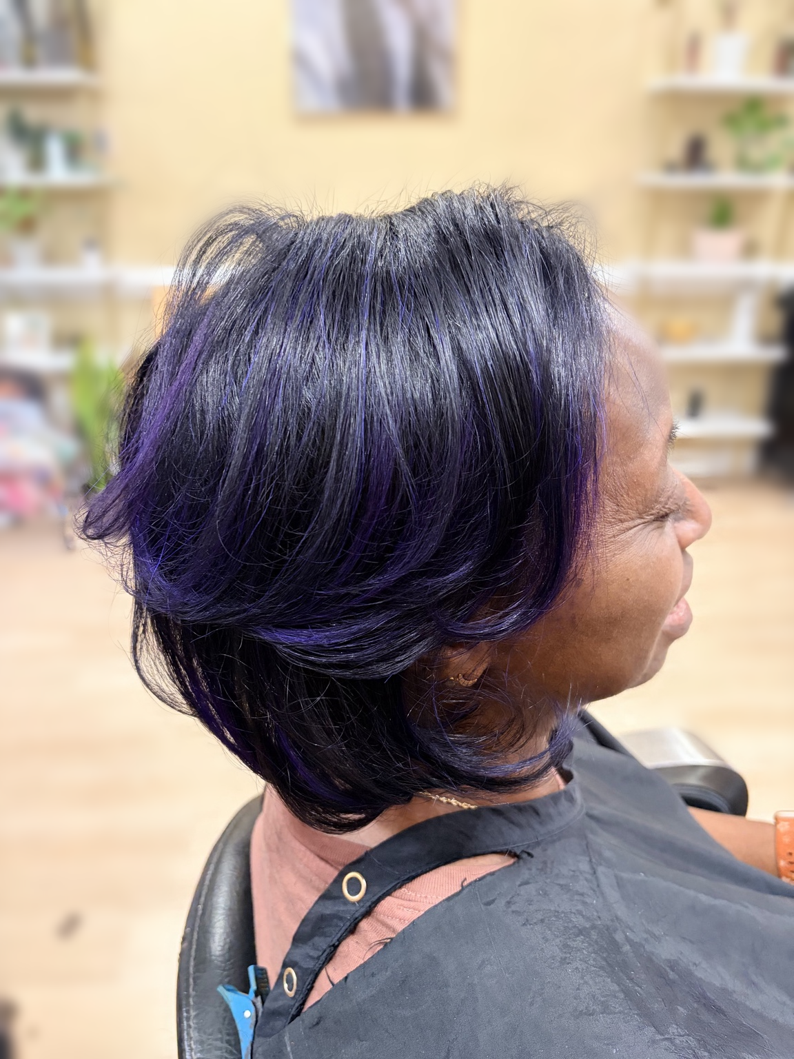 Purple-toned feathered layers at TEXTURES Hair Salon