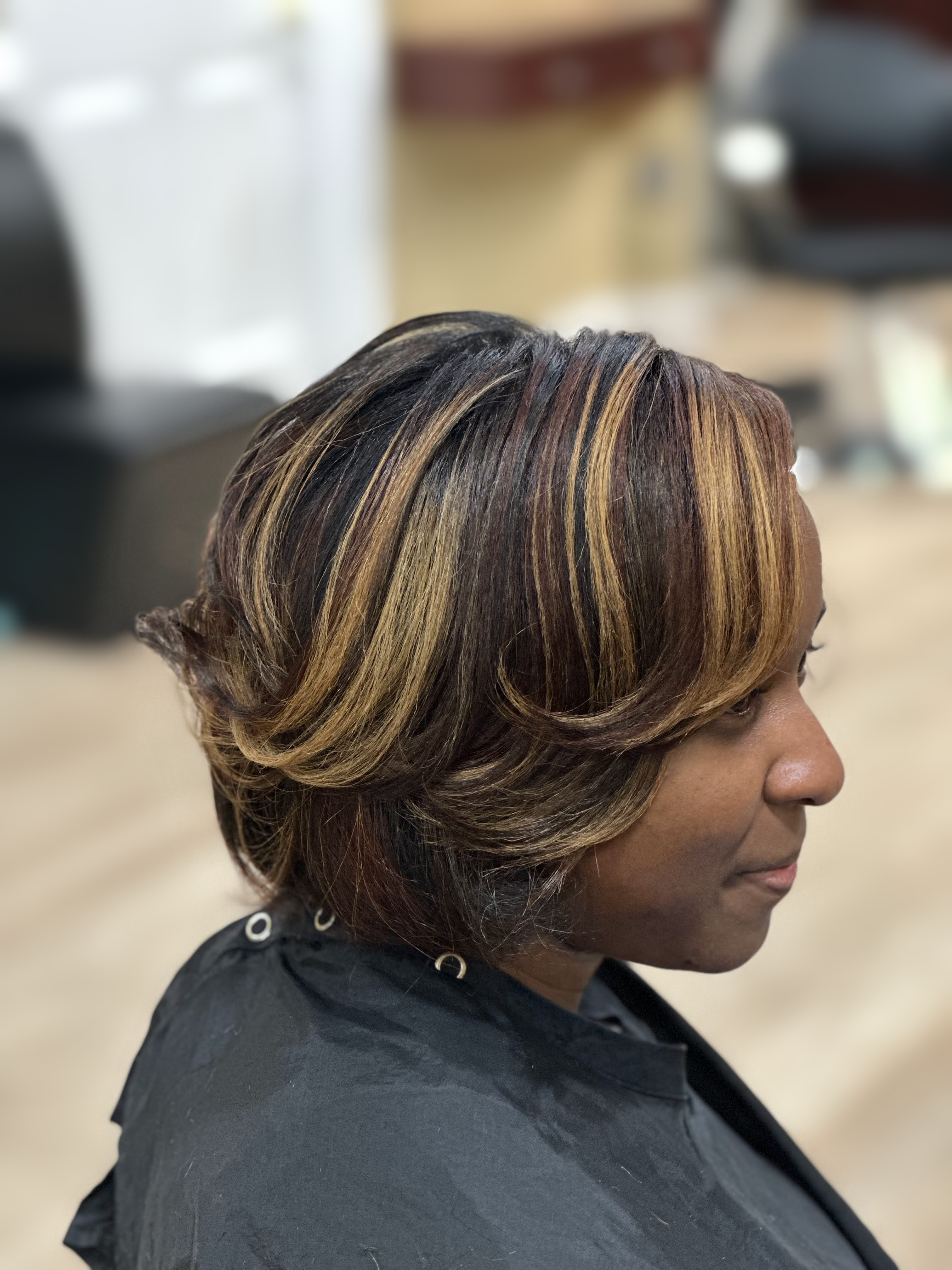 Caramel-highlighted feathered bob at TEXTURES Hair Salon