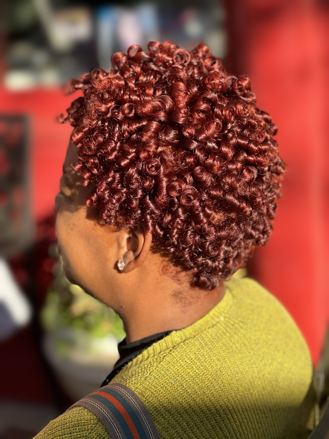 Copper-red short defined curls at TEXTURES Hair Salon