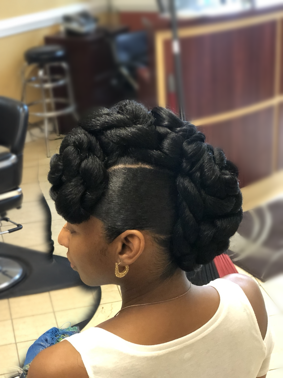 Sculpted twisted updo with a tapered side at TEXTURES Hair Salon