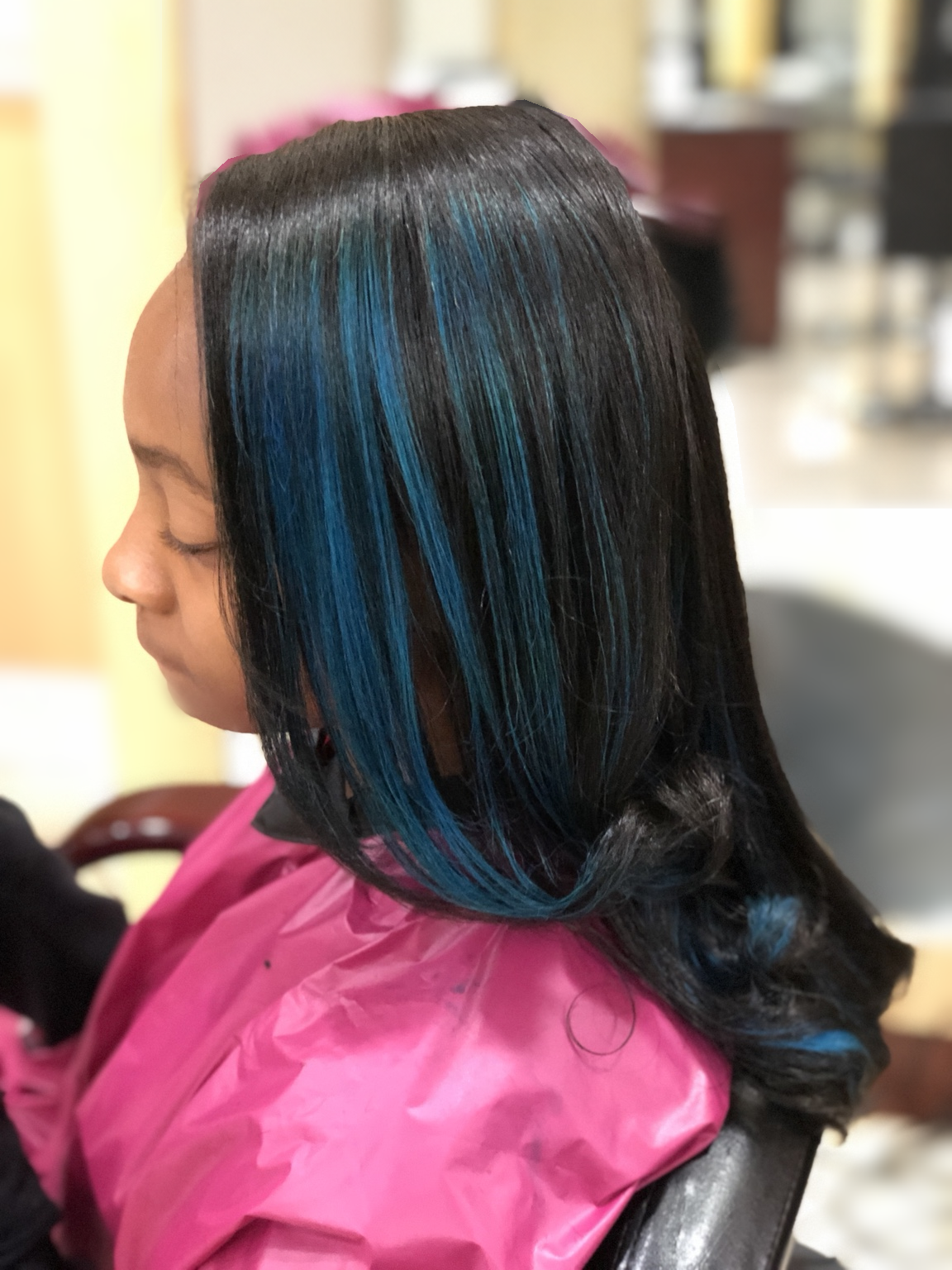Blue-accented smooth layers with curled ends at TEXTURES Hair Salon