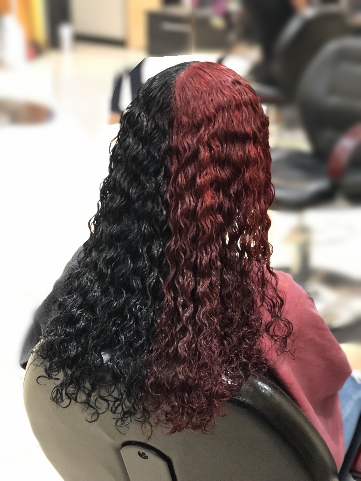 Black-and-burgundy defined curls at TEXTURES Hair Salon