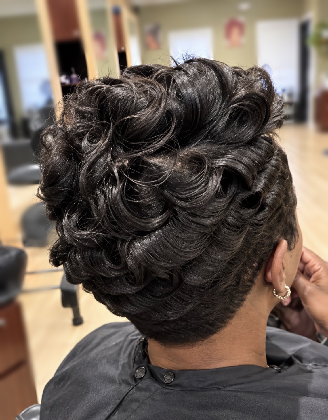Short sculpted curls with a tapered nape at TEXTURES Hair Salon